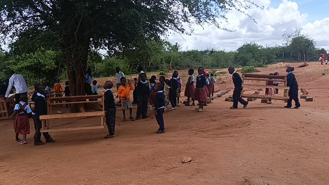 Children outside a newly built classroom