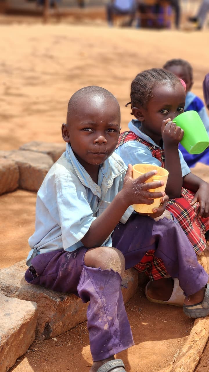 A caregiver guiding a young girl